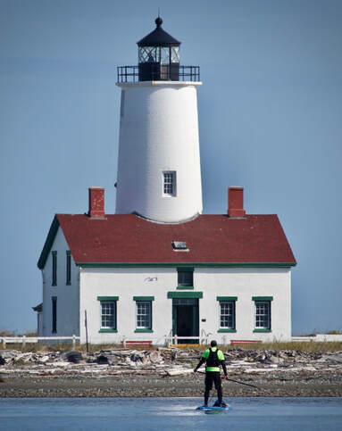 New Dungeness Lighthouse, standup paddleboarder Shanon Dell Given to Glide